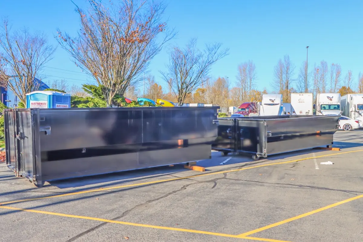 Professional dumpster rental service with roll-off container on residential driveway in Security-Widefield